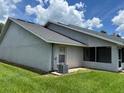 Exterior side view of the home with a screen porch and well-maintained lawn at 888 W Stuart St, Bartow, FL 33830