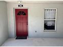 Close-up of the front door and entry of the home, including address number and sidelight window at 888 W Stuart St, Bartow, FL 33830