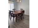 Formal dining room with wood flooring, a chandelier, and an elegant wood table with upholstered chairs at 5523 Westview Dr, Orlando, FL 32810