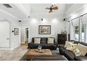Inviting living room featuring a high ceiling, a leather sofa, and a large picture window providing ample natural light at 1485 Waukon Cir, Casselberry, FL 32707