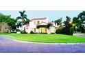 Beautiful home with a well-manicured lawn, lush landscaping, and inviting curb appeal on a brick road at 1234 W Ivanhoe Blvd, Orlando, FL 32804
