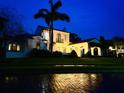 Elegant home illuminated at night, featuring a lush lawn and mature palm tree, creating a warm ambiance at 1234 W Ivanhoe Blvd, Orlando, FL 32804