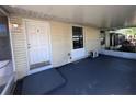 Covered porch featuring a freshly painted floor, a ceiling light, and an exterior door at 4395 E Michigan St # 4395, Orlando, FL 32812