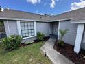 This front yard features well manicured landscaping and a concrete walkway to the home's entrance at 1980 Water Ln, Maitland, FL 32751