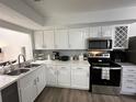 Bright updated kitchen with modern stainless steel appliances and white cabinetry at 1980 Water Ln, Maitland, FL 32751