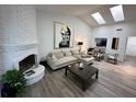 Bright living room boasts vaulted ceilings with skylights, fireplace and modern decor at 1980 Water Ln, Maitland, FL 32751