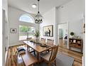 Bright dining room showcasing natural light, wood floors, a modern chandelier, and seating for six at 1437 Abberton Dr, Orlando, FL 32837