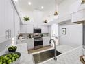 Modern kitchen featuring white cabinets, stainless steel appliances, sleek countertops, and recessed lighting at 1437 Abberton Dr, Orlando, FL 32837