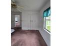 Cozy bedroom with carpeted floors and a closet, perfect for restful nights at 860 S Grove St, Eustis, FL 32726