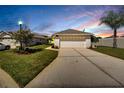 Evening view of the house, garage, and driveway at 2178 Sunstone Dr, Lakeland, FL 33813