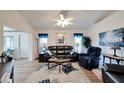 Living room with leather furniture, wood floors, and large windows at 2178 Sunstone Dr, Lakeland, FL 33813