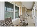 Relaxing front porch with rocking chairs and white railing at 2375 Miles Ct, Lakeland, FL 33812