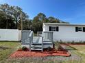 Gray deck with stairs leading to the backyard at 7612 Glen Meadow Dr, Lakeland, FL 33810