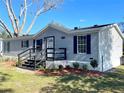 Gray manufactured home with black accents and landscaping at 9619 Moore Rd, Lakeland, FL 33809