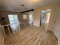 Open living area featuring wood flooring, a brick fireplace, and access to a sunroom at 1024 Driggers Rd, Lakeland, FL 33809