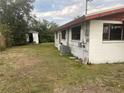 Backyard view of a single story house with shed at 121 7Th Terrace Wahneta Way, Winter Haven, FL 33880