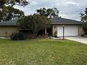 House with a two car garage and lush green lawn at 2062 Katie Ct, Winter Haven, FL 33884