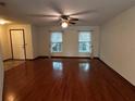 Spacious living room with hardwood floors and two windows at 2062 Katie Ct, Winter Haven, FL 33884