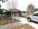 House exterior with driveway and chain link fence at 217 Bay E St, Davenport, FL 33837