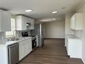 Modern kitchen featuring stainless steel appliances, white cabinets, and a sleek backsplash at 4128 W Bella Vista St, Lakeland, FL 33810