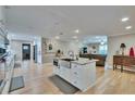 Open-concept kitchen featuring an island with sink, granite countertops, and stainless steel appliances at 4523 Hallamview Ln, Lakeland, FL 33813