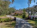 Long driveway leading to a charming house nestled among trees at 465 Rowland Ct, Bartow, FL 33830