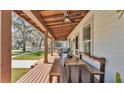 Inviting covered porch with wooden floors, seating, and a dining table for outdoor enjoyment at 520 E Stanford St, Bartow, FL 33830