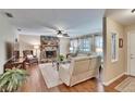 Inviting living room featuring a stone fireplace, hardwood floors, and comfortable seating at 7929 Chase Rd, Lakeland, FL 33810