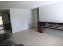 Bright and airy living room with tile flooring and a classic wood console at 112 Bishop St, Auburndale, FL 33823