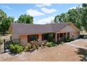 Charming single-story home featuring manicured lawn, attached garage, and red shutters at 1600 Alma Ct, Bartow, FL 33830