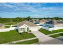 Aerial view of a single-story home with a well-manicured lawn and a two-car garage at 1835 Jackson Oaks Dr, Bartow, FL 33830
