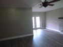 Bright living room with gray laminate floors and view of the back patio at 1835 Mount Pisgah Rd, Fort Meade, FL 33841