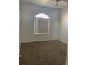 Cozy bedroom featuring plush carpeting, a vaulted ceiling, and a bright window at 184 Ocean Bluff Dr, Poinciana, FL 34759