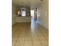 Open living room boasts tile floors and seamless flow to kitchen, perfect for entertaining at 184 Ocean Bluff Dr, Poinciana, FL 34759