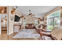Comfortable living room featuring hardwood floors, leather sofas, natural lighting, and vaulted ceiling at 1850 Saddlewood Pl, Bartow, FL 33830