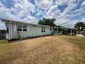 Well-maintained single-story home featuring a covered carport and mature landscaping at 2055 S Floral Ave # 262, Bartow, FL 33830