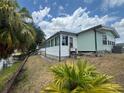 Exterior view showing a single-story home with a sunroom addition and access to waterfront at 2055 S Floral Ave # 262, Bartow, FL 33830