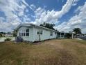 Single-story home with a covered carport and mature landscaping near the water at 2055 S Floral Ave # 262, Bartow, FL 33830