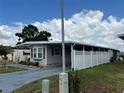 Charming single story home with a covered driveway and a well-maintained white picket fence at 2055 S Floral Ave # 69, Bartow, FL 33830