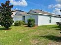 Exterior of a well-maintained single story home with attractive landscaping at 264 Fiddlewood Ct, Davenport, FL 33837