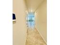 Hallway with tile flooring leading to an open floor plan and modern interior at 264 Fiddlewood Ct, Davenport, FL 33837