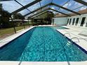 Sparkling screened-in pool with crystal-clear water, providing a refreshing oasis for relaxation and recreation at 2742 Pine Acres Dr, Lake Wales, FL 33898