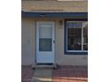 Classic front entry featuring a sturdy white door and matching window with blue accents at 294 Winter Ridge Blvd # 294, Winter Haven, FL 33881