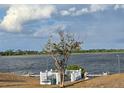 Picturesque waterfront view of the lake, enhanced by a charming gazebo and lush greenery at 294 Winter Ridge Blvd # 294, Winter Haven, FL 33881