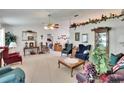 Spacious living room featuring a vaulted ceiling, ceiling fan, and comfortable seating at 3154 Prairie Dunes W Cir, Lakeland, FL 33810
