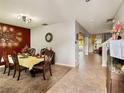 Inviting dining room with a decorative wall, extending into a spacious area with tile flooring at 3334 Fawnwood Dr, Ocoee, FL 34761