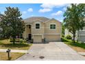 Inviting two-story home with a spacious driveway, two-car garage, and a beautifully landscaped front yard at 3334 Fawnwood Dr, Ocoee, FL 34761