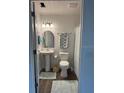 Compact bathroom with pedestal sink, decorative mirror, and shower at 4140 Old Dixie Hwy, Auburndale, FL 33823