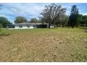 Ranch-style home with large front yard and mature oak trees at 4151 Boggy Creek Rd, Kissimmee, FL 34744