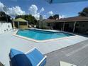 Backyard oasis with a pool, shed, lounge chairs, and a covered patio at 4805 Oak Acres Dr, Lake Wales, FL 33898